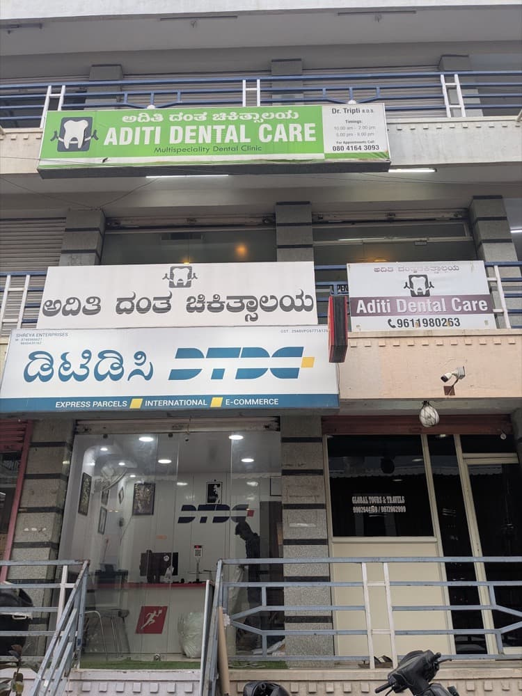 Aditi Dental Care signboard on the first floor at Ambalipura-Sarjapur Road, above the DTDC parcel office